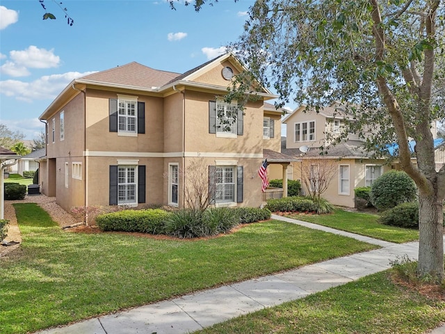 view of front of house featuring a front lawn and stucco siding