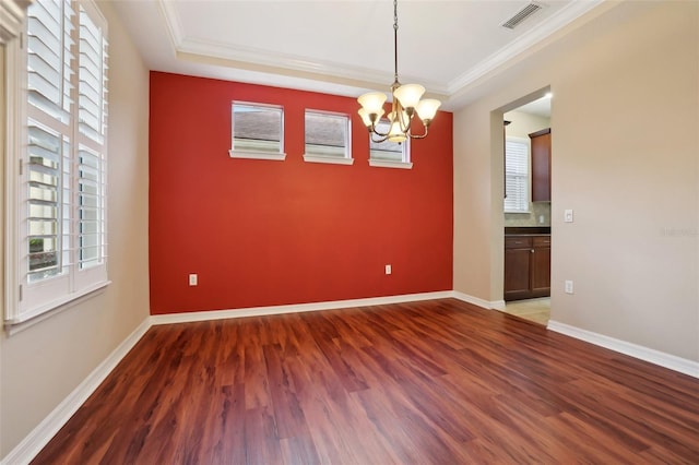 empty room featuring dark wood-type flooring, visible vents, and baseboards