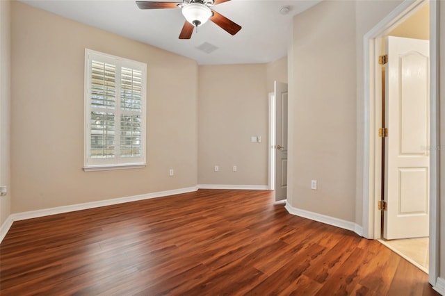 unfurnished bedroom featuring dark wood-type flooring, visible vents, and baseboards