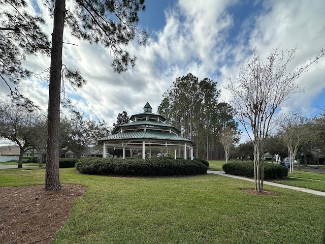 view of front of home with a front lawn and a gazebo