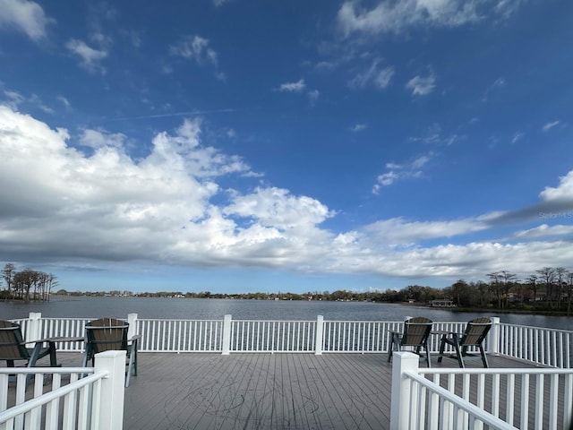 exterior space featuring a deck with water view