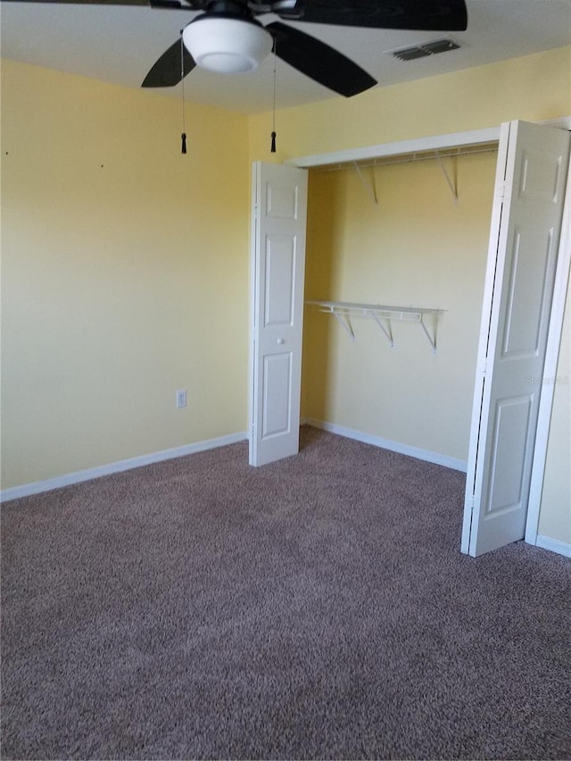 5455 Vineland Rd Unit 3303, Orlando, FL 32811 - unfurnished bedroom featuring carpet flooring, a ceiling fan, and a closet