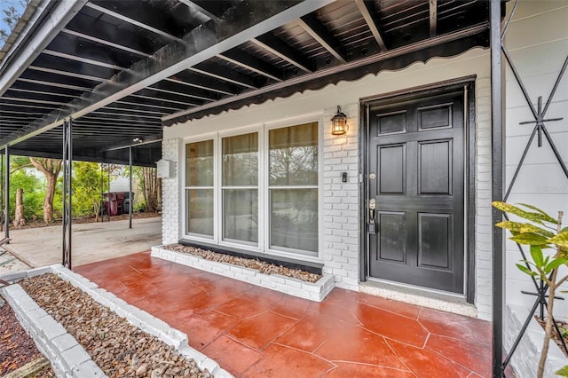 doorway to property with brick siding