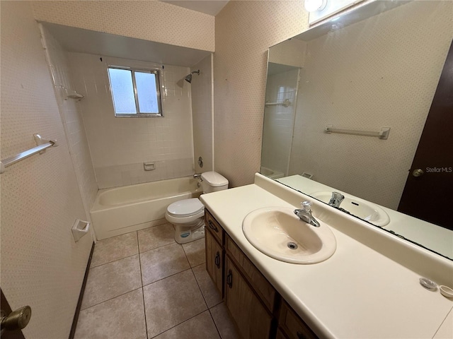 full bathroom featuring tile patterned floors, toilet, vanity, and tiled shower / bath