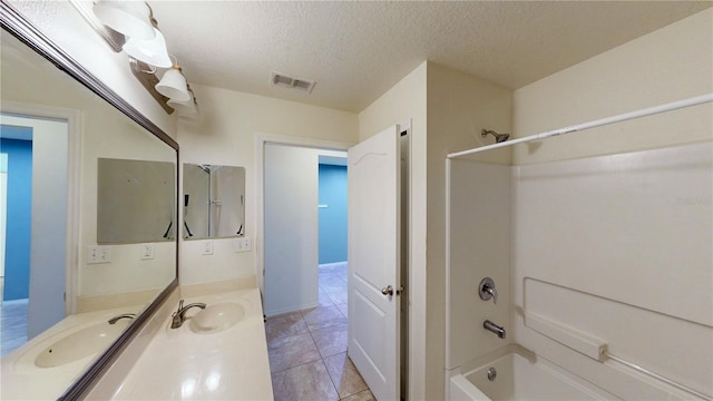 bathroom with visible vents, shower / bathing tub combination, a textured ceiling, vanity, and tile patterned floors