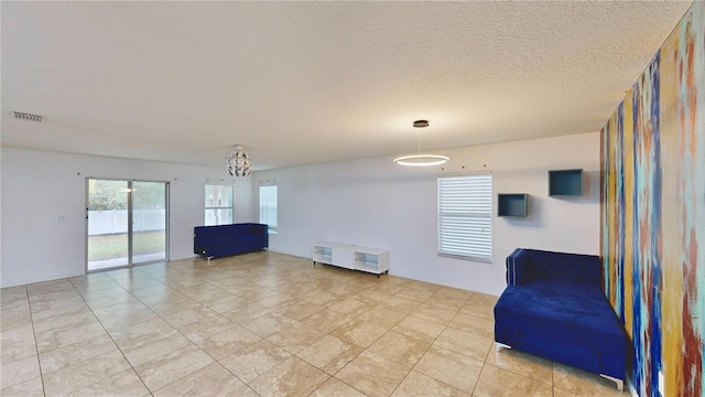 unfurnished room featuring a textured ceiling and visible vents