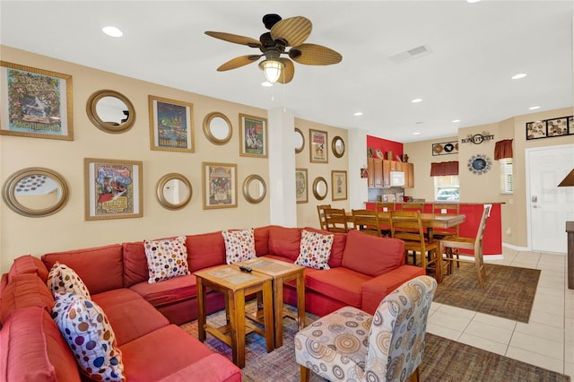 living area with light tile patterned floors, recessed lighting, visible vents, a ceiling fan, and baseboards