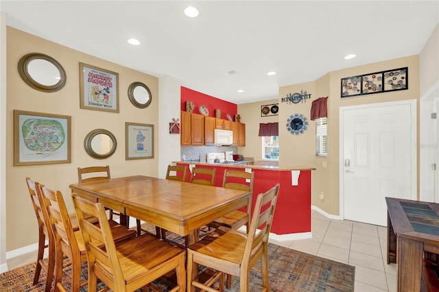 dining area with recessed lighting, baseboards, and light tile patterned floors