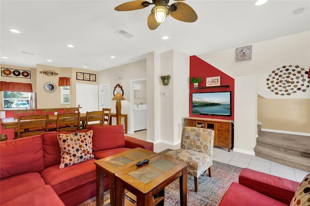 living room with light tile patterned floors, washing machine and dryer, visible vents, and recessed lighting