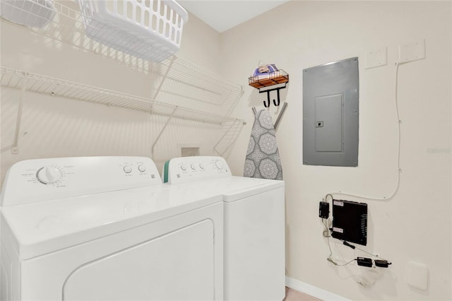 laundry area with laundry area, electric panel, baseboards, and separate washer and dryer