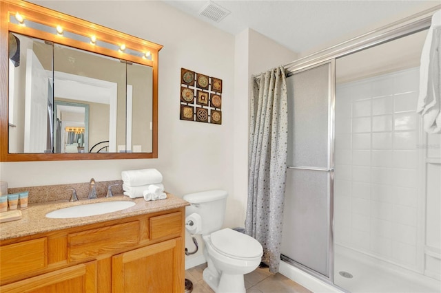 bathroom with a stall shower, visible vents, toilet, tile patterned floors, and vanity