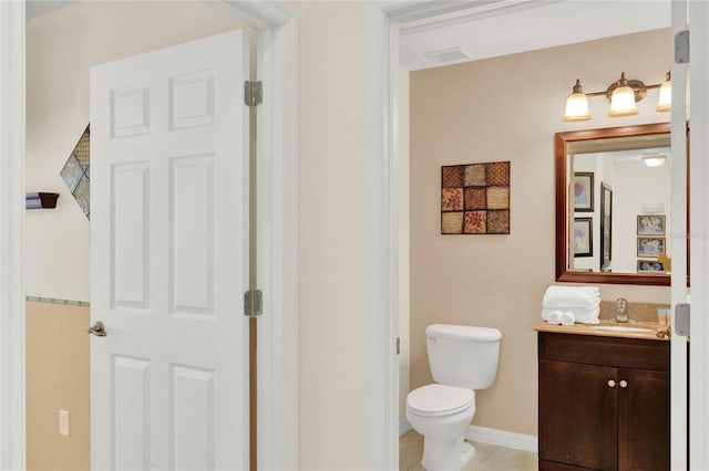 bathroom featuring visible vents, toilet, vanity, tile patterned flooring, and baseboards