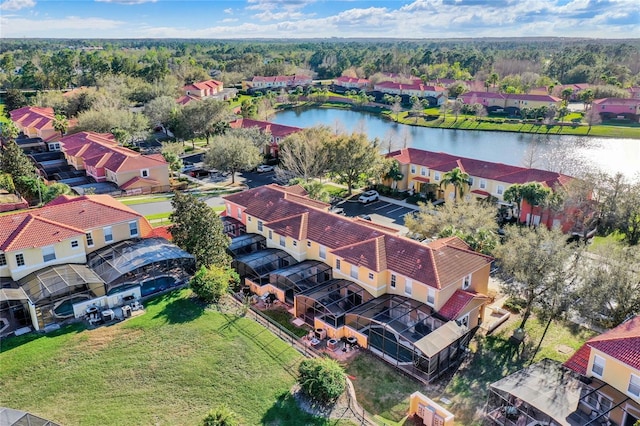 drone / aerial view with a residential view and a water view