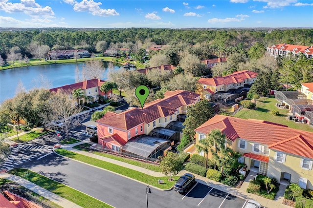 drone / aerial view featuring a water view and a residential view