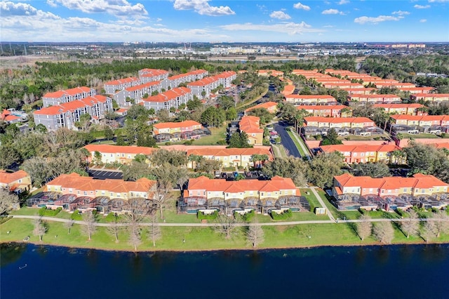 drone / aerial view featuring a residential view and a water view