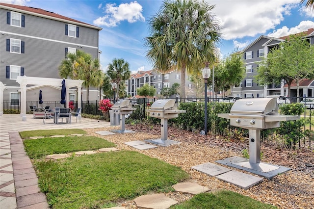 view of community with mail area, fence, and a residential view