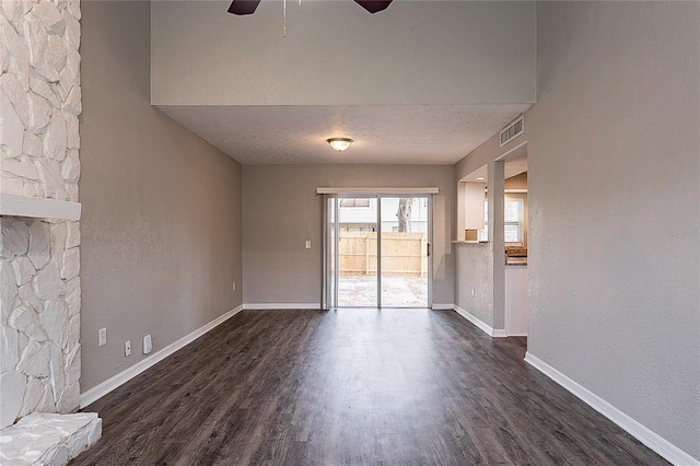 unfurnished room featuring baseboards, visible vents, and dark wood-type flooring