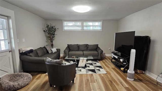 living room featuring light wood-type flooring and a wealth of natural light