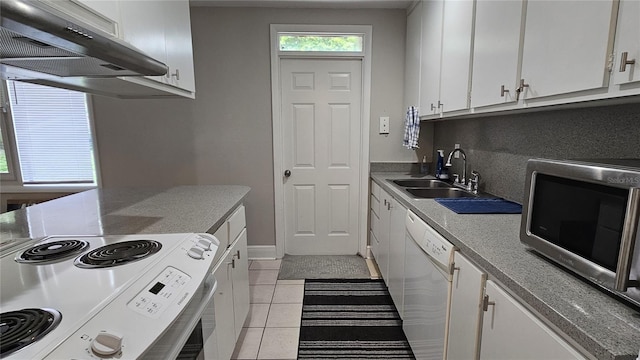 kitchen with light tile patterned flooring, sink, white appliances, and white cabinets