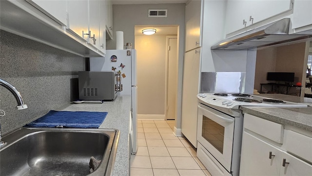 kitchen featuring light tile patterned flooring, white cabinetry, sink, and white electric stove