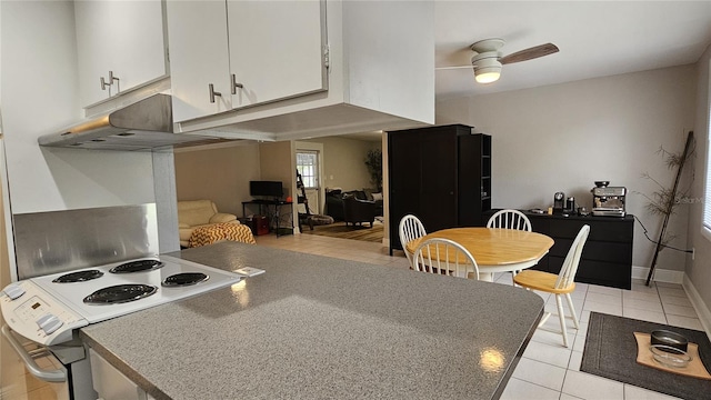 kitchen featuring ceiling fan, light tile patterned flooring, white cabinetry, and white electric range