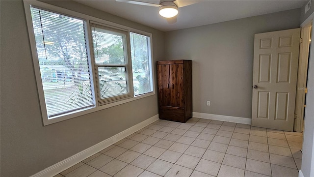 tiled empty room with ceiling fan