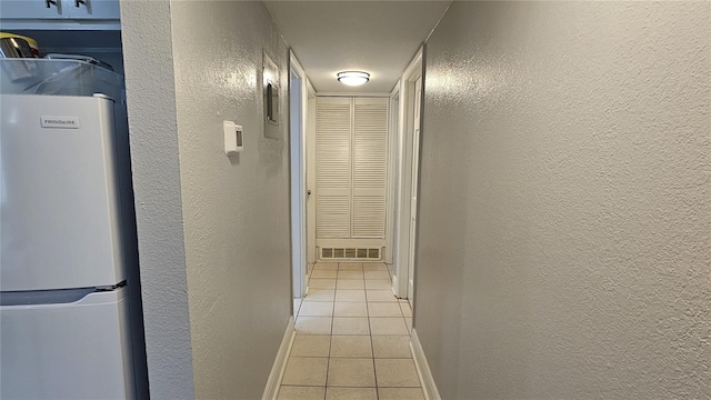 hallway with light tile patterned floors