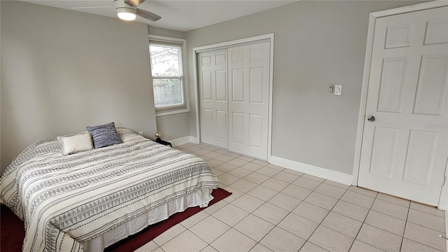 tiled bedroom featuring a closet and ceiling fan