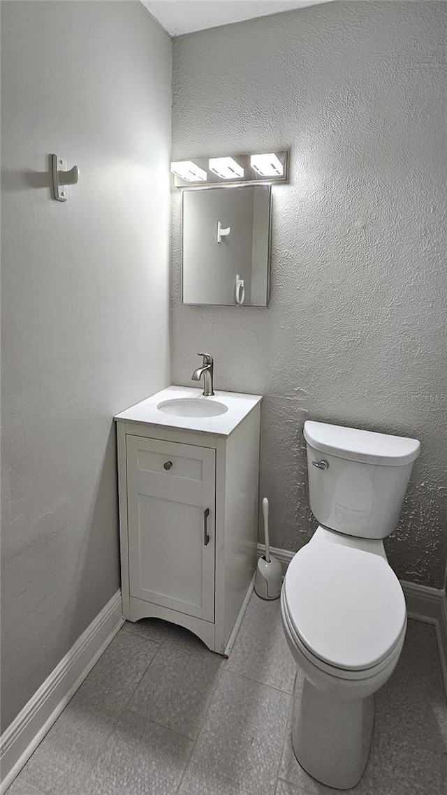 bathroom featuring toilet and vanity