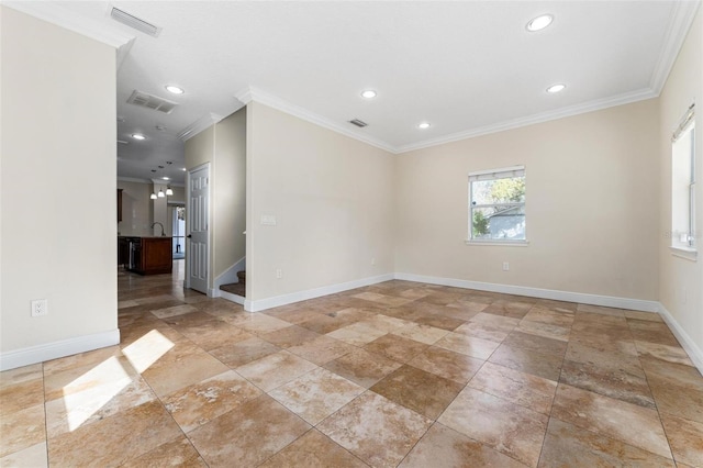 unfurnished room featuring baseboards, visible vents, and crown molding