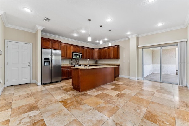 kitchen featuring pendant lighting, crown molding, visible vents, appliances with stainless steel finishes, and an island with sink