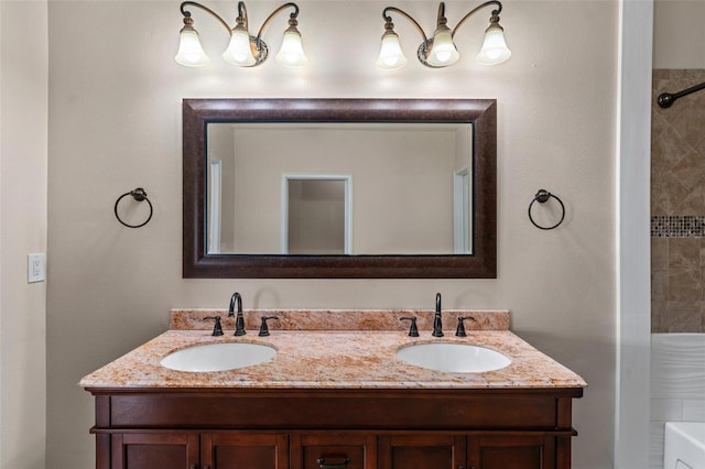 full bath featuring double vanity, a sink, and walk in shower