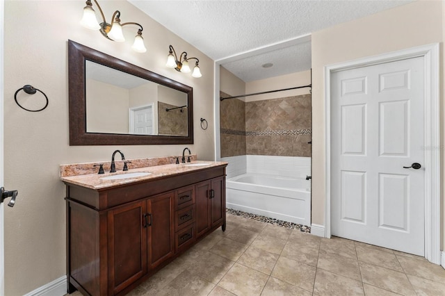 full bath with tile patterned flooring, a sink, a textured ceiling, and double vanity