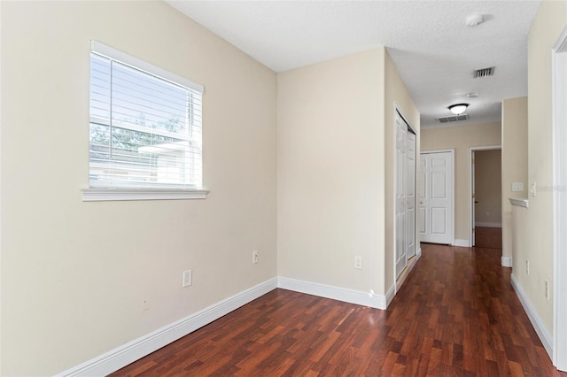 interior space featuring wood finished floors, visible vents, and baseboards