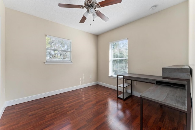 office area featuring a textured ceiling, wood finished floors, a wealth of natural light, and baseboards