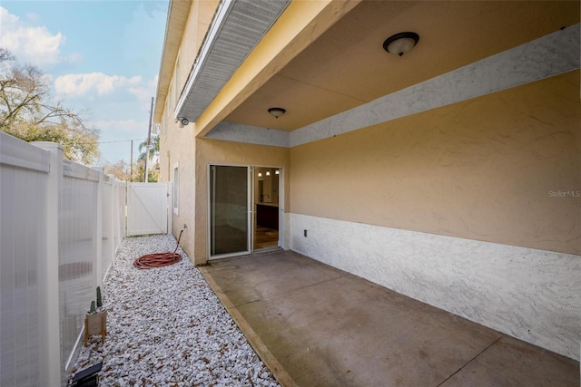 view of patio / terrace featuring fence and a gate