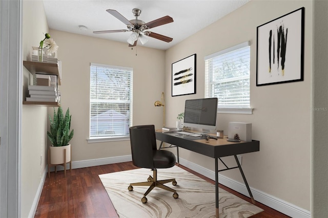 office area with a ceiling fan, a healthy amount of sunlight, baseboards, and wood finished floors