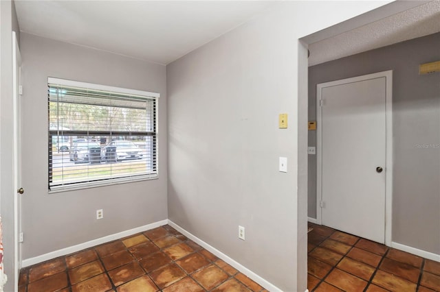 empty room featuring baseboards