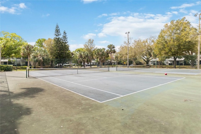 view of tennis court with fence