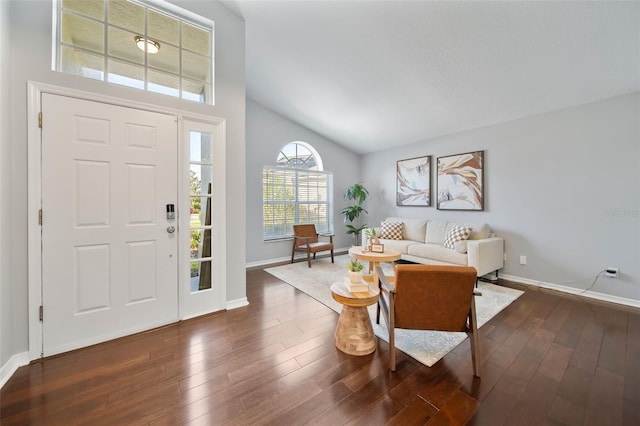 entrance foyer with dark wood-style floors, high vaulted ceiling, and baseboards