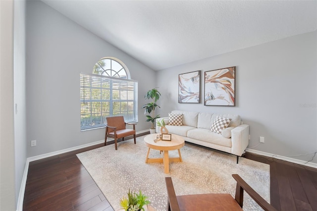 living room featuring lofted ceiling, dark wood-style flooring, a textured ceiling, and baseboards