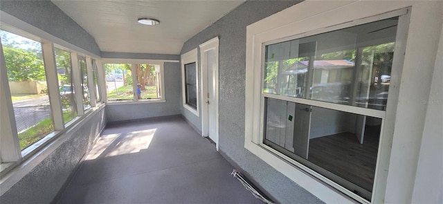 unfurnished sunroom featuring lofted ceiling