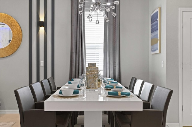 tiled dining area featuring a chandelier