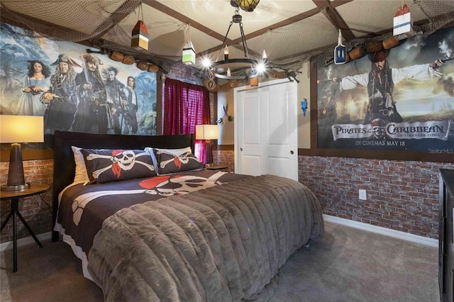 bedroom with carpet, a notable chandelier, and brick wall