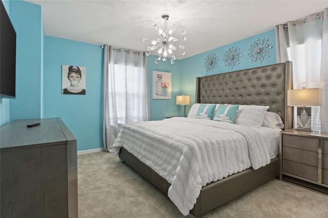 carpeted bedroom featuring a chandelier