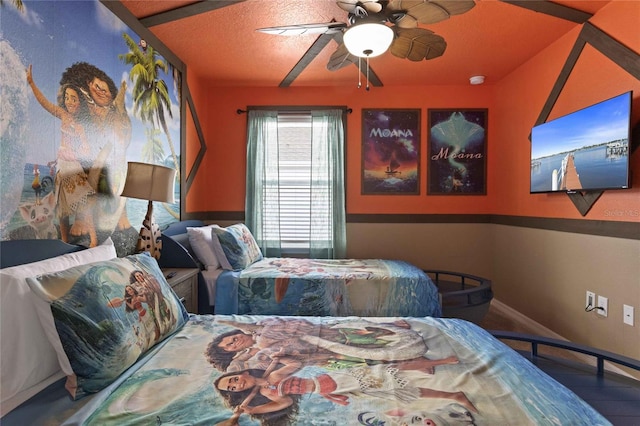 bedroom featuring hardwood / wood-style flooring, ceiling fan, and a textured ceiling