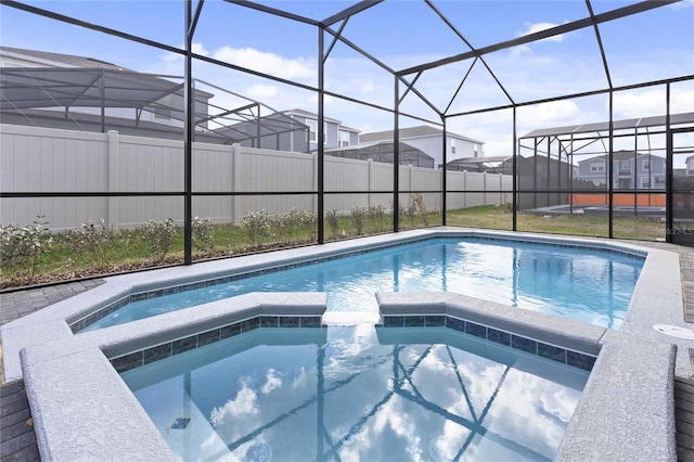 view of swimming pool featuring an in ground hot tub and glass enclosure