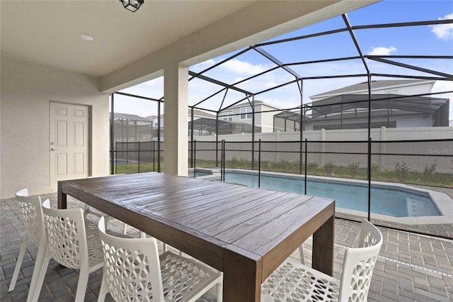 view of swimming pool featuring a patio area and glass enclosure