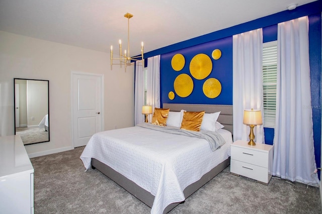 carpeted bedroom featuring baseboards and an inviting chandelier