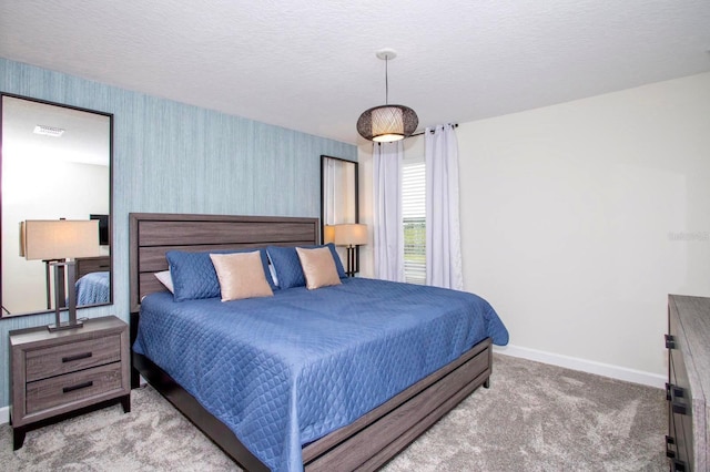 bedroom with light carpet, wallpapered walls, visible vents, and baseboards